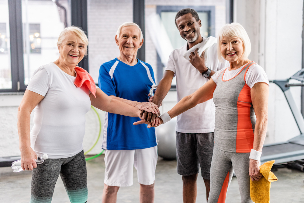 A happy group of friends participate in a group fitness class at the best independent living in Elkhorn