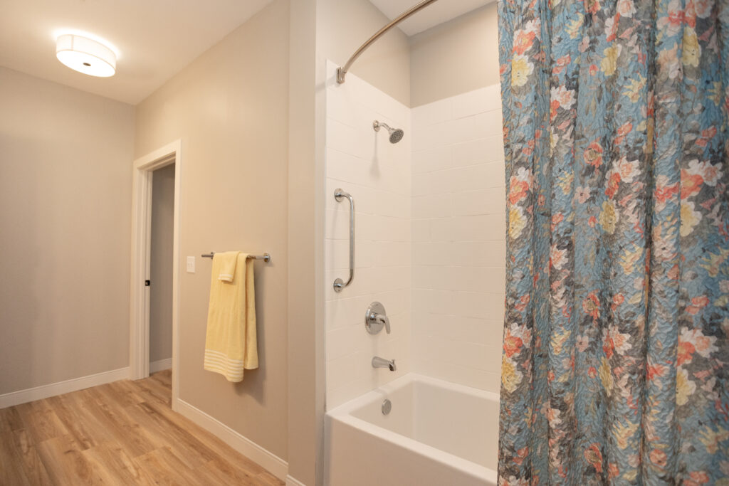 A bathtub is in the second bathroom in a two bedroom apartment
